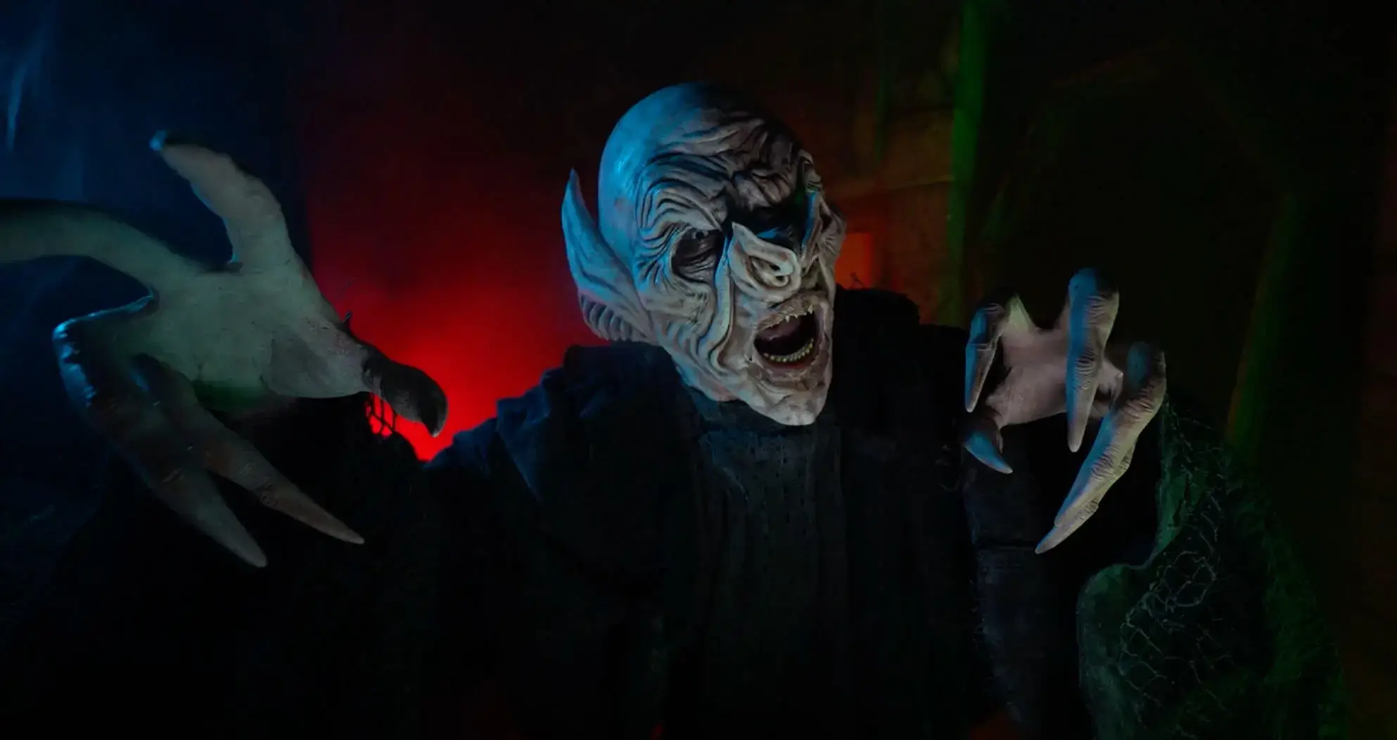 Pale vampire creature raising claws inside Surrey haunt