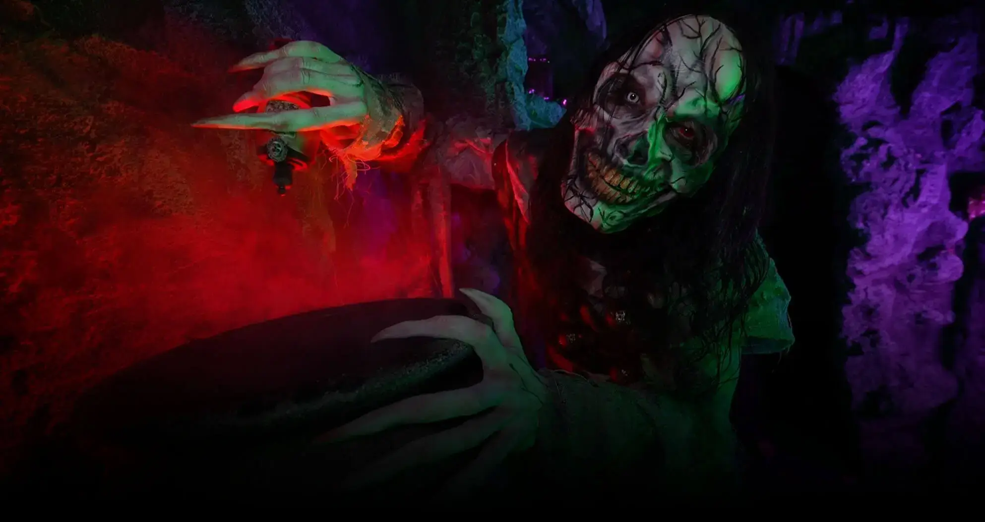 Green-faced demon lunging in red mist at BC haunted house